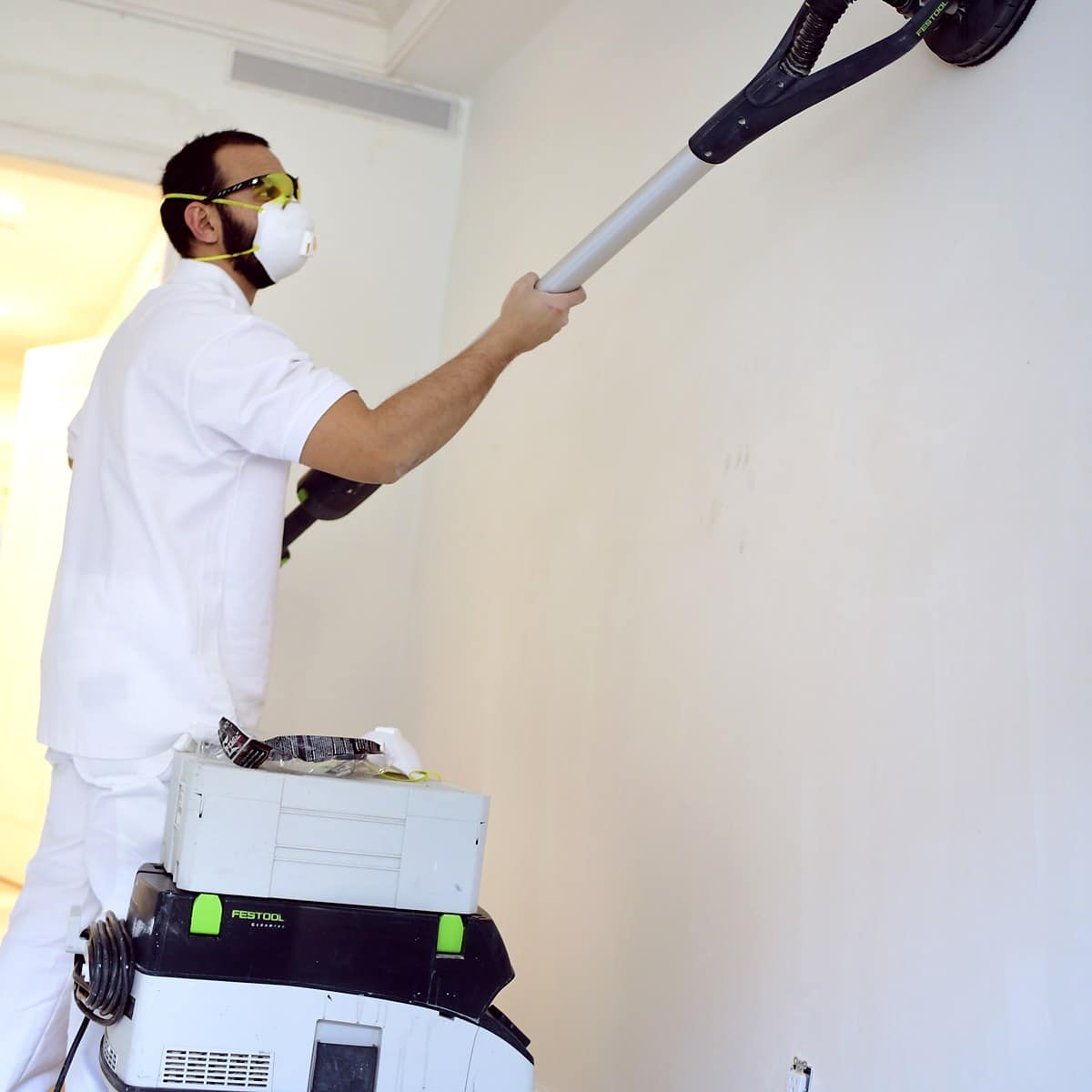 Elite Painting Services sanding interior walls before painting